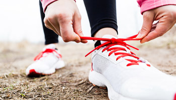 women-tying-running-shoes